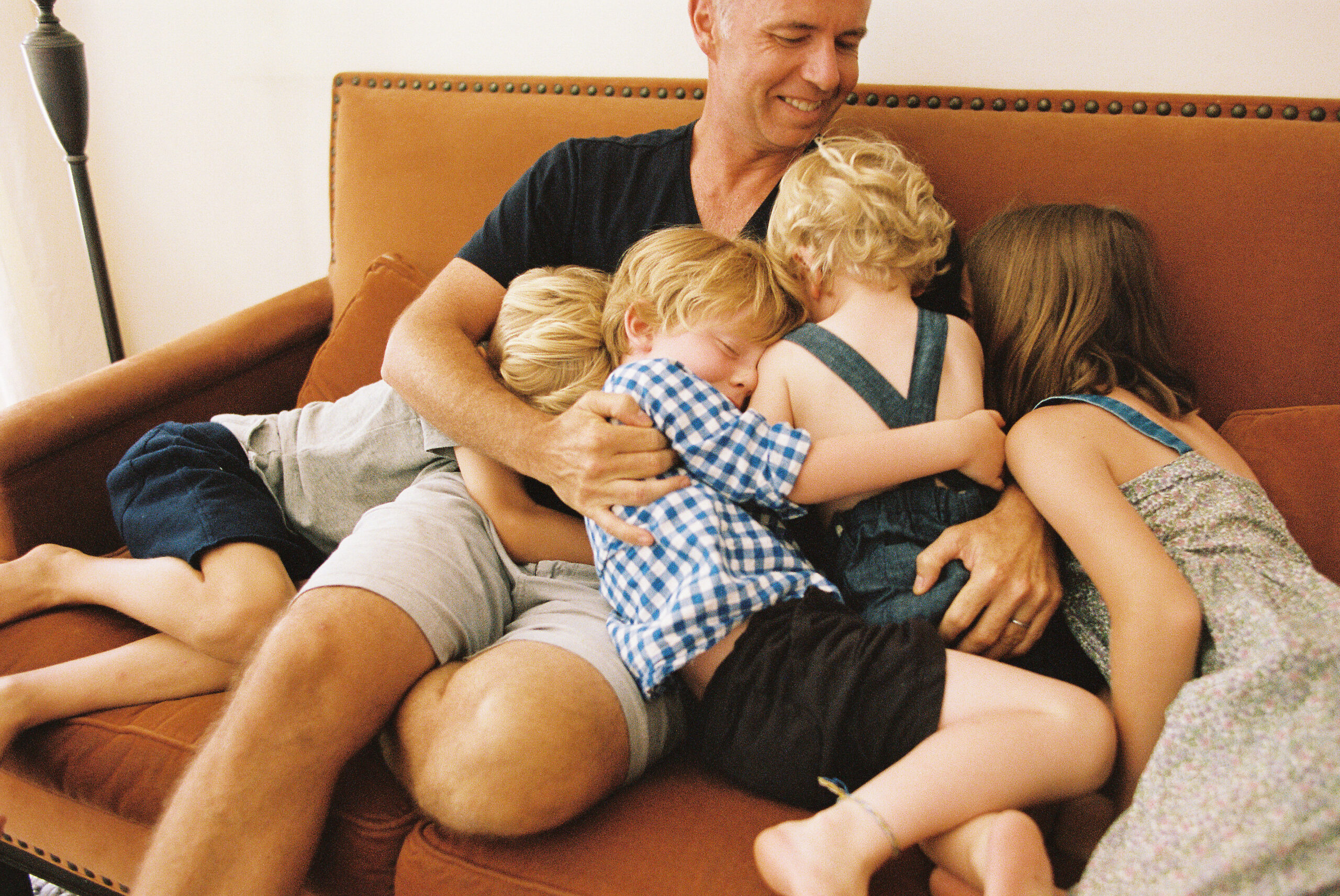 Parent using Gottman's emotion coaching method with upset child during a public meltdown