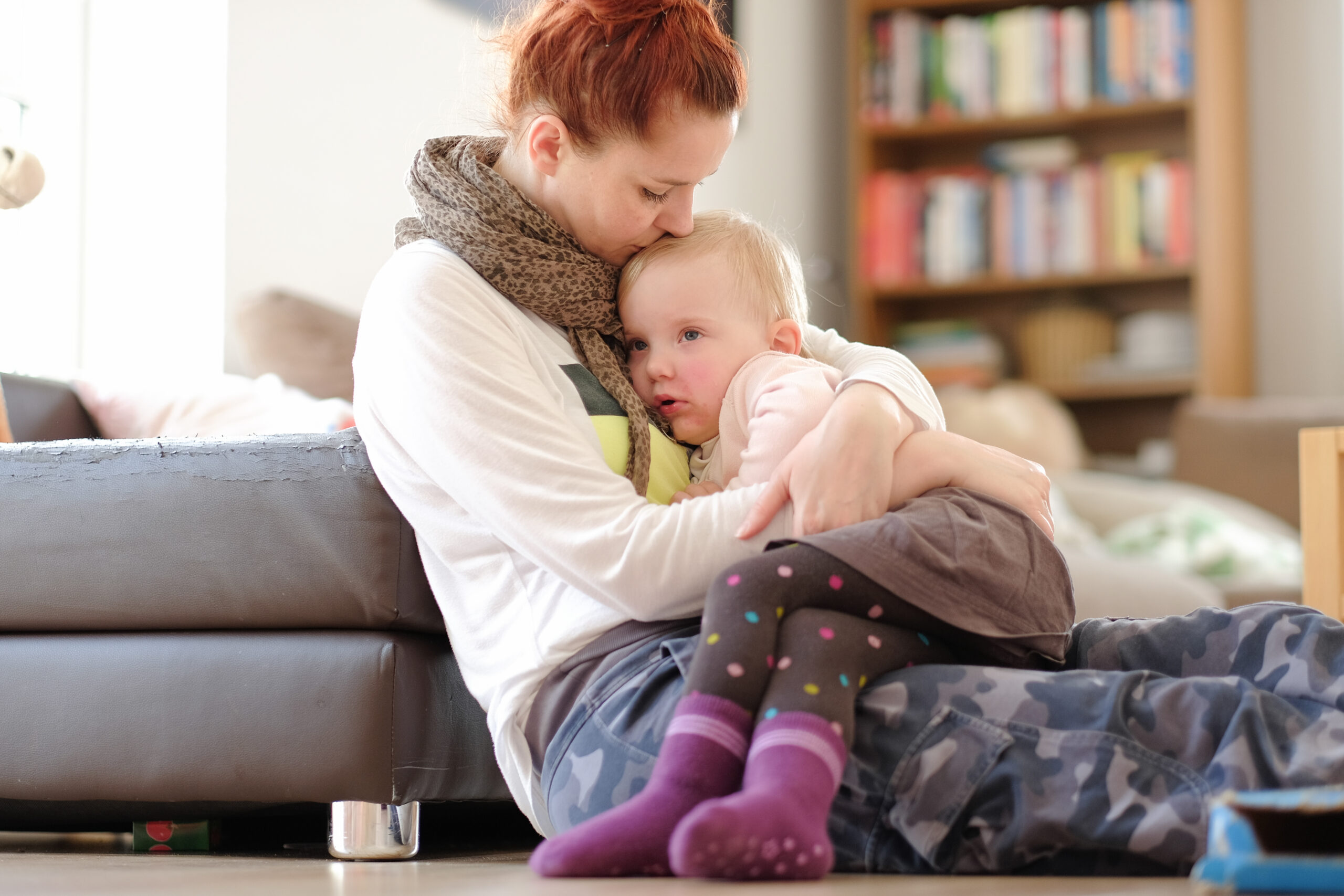 Parent calmly comforting overwhelmed child - co-regulation in parenting with grace