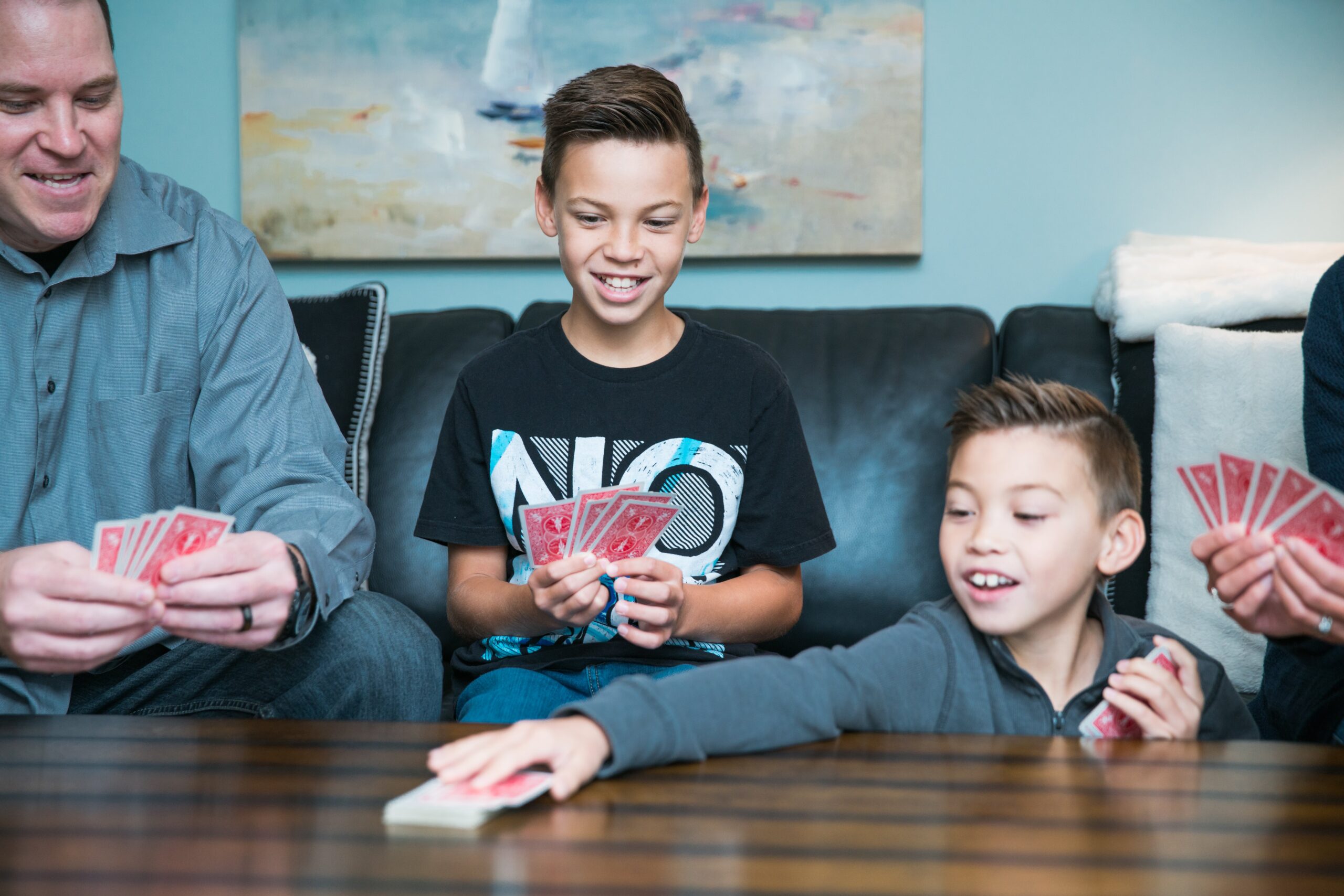 Child sorting matching pairs of playing cards for Old Maid game
