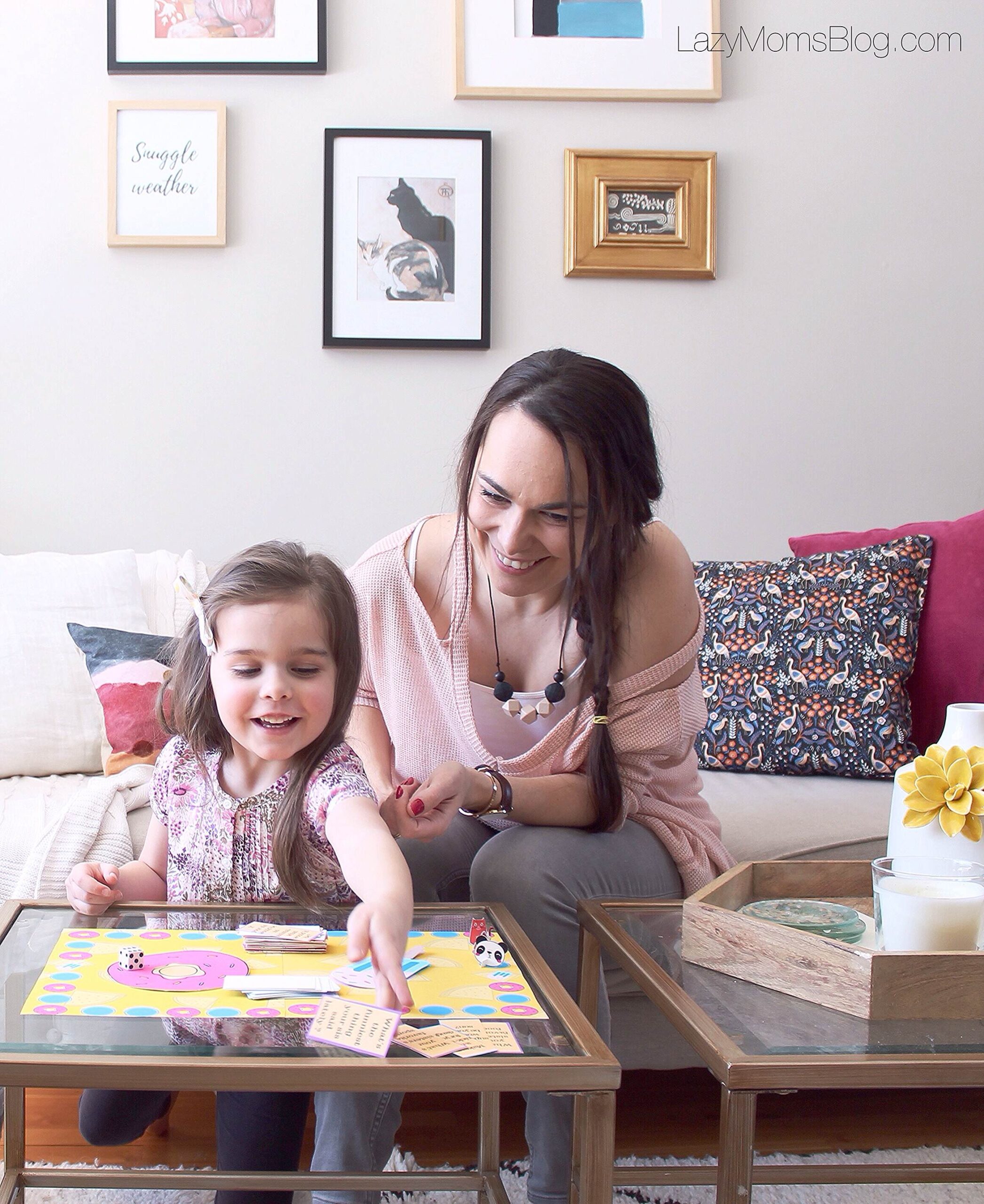 Mother and daughter playing a vocabulary buzzer game at the kitchen table