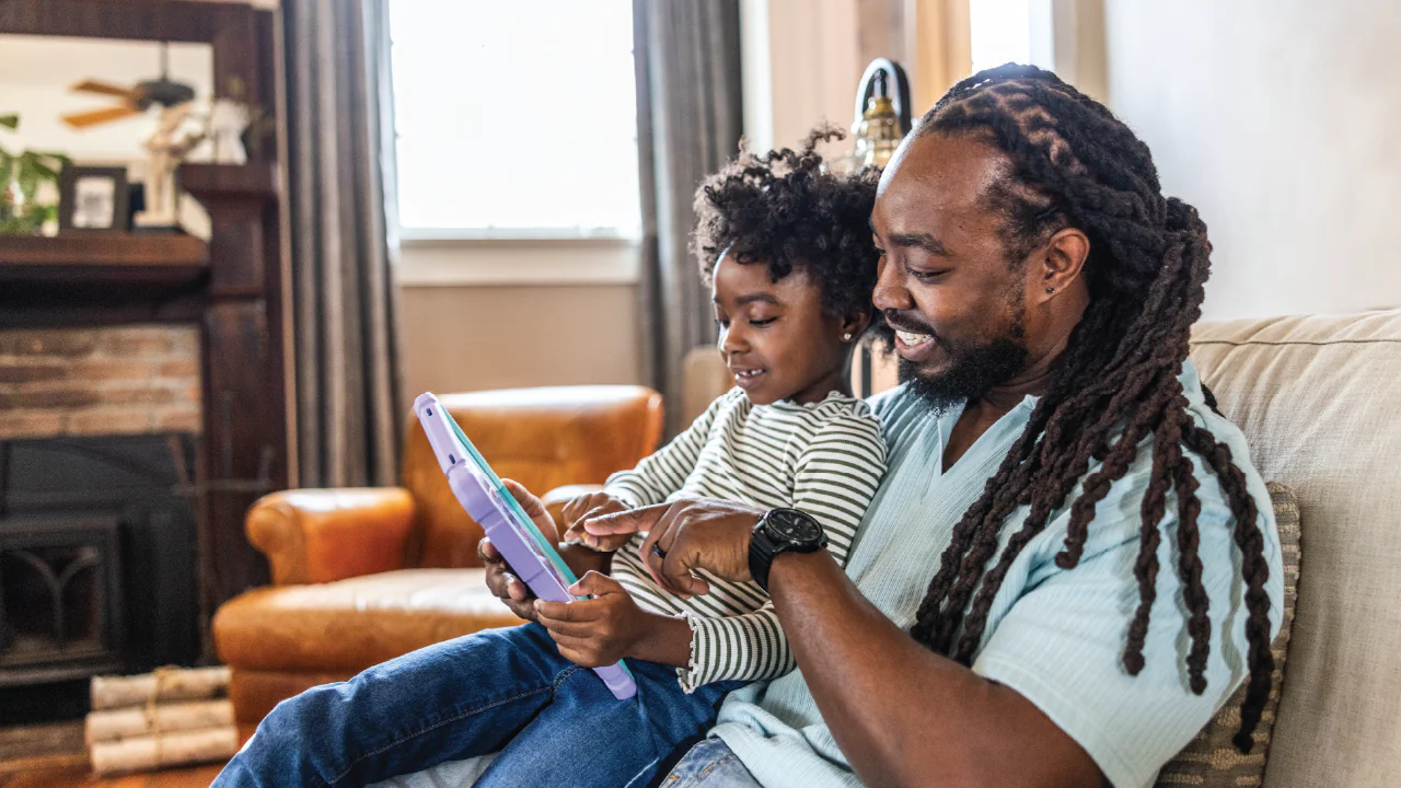 Child using tablet with autoplay video, parent setting healthy screen time limits in 2025