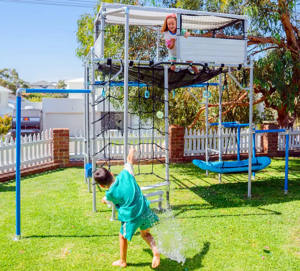 Older kids playing water balloon piñata in backyard