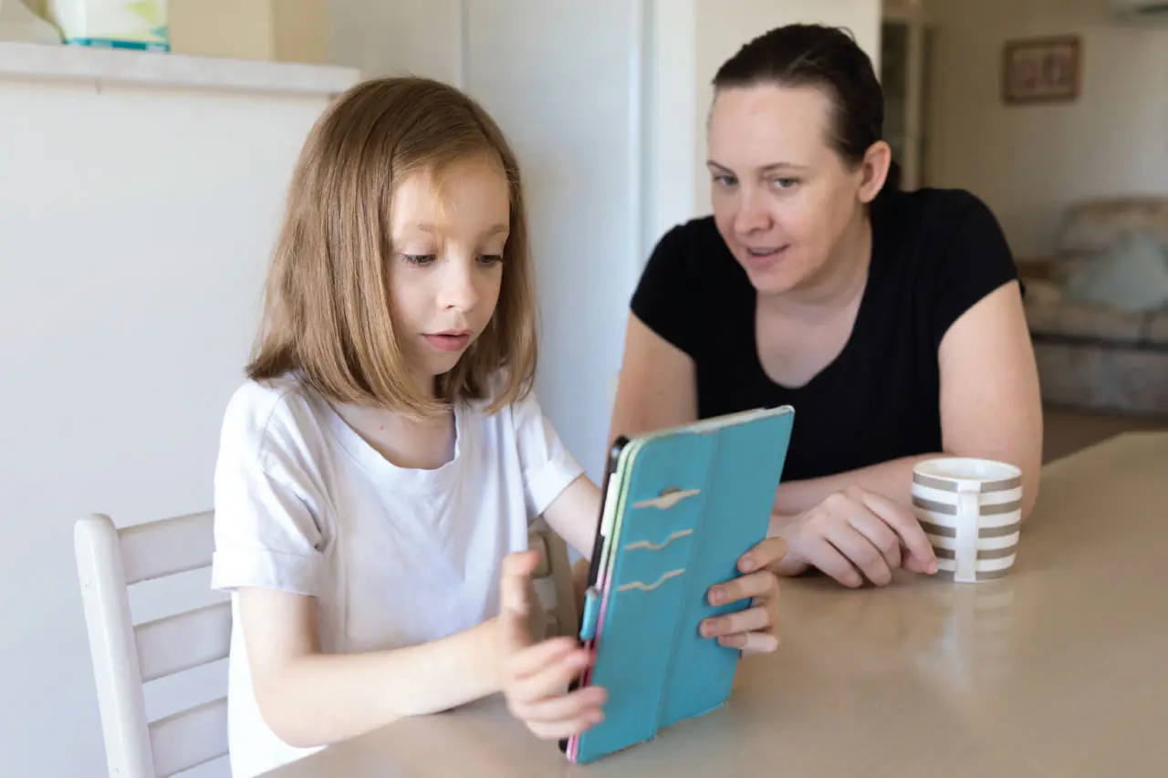 Child from low income family using Khan Academy tablet screen time benefits educational equity